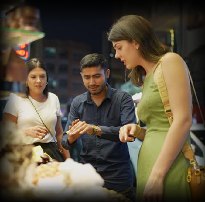 Traveler negotiating with a local vendor at a busy Asian night market